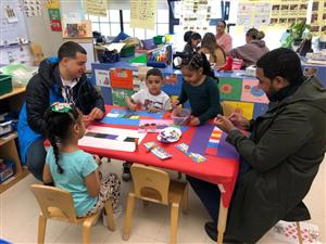 Parents and children working together in the classroom.